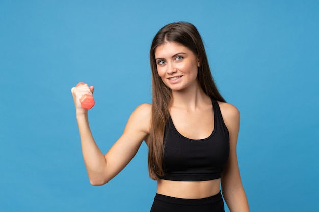 Young girl woman over isolated  making weightlifting