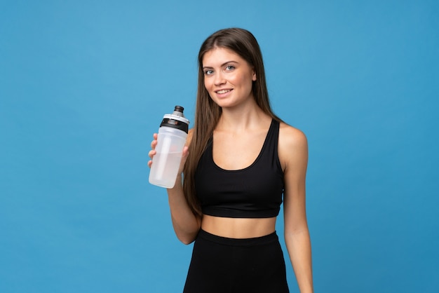 Young girl woman over isolated  with sports water bottle