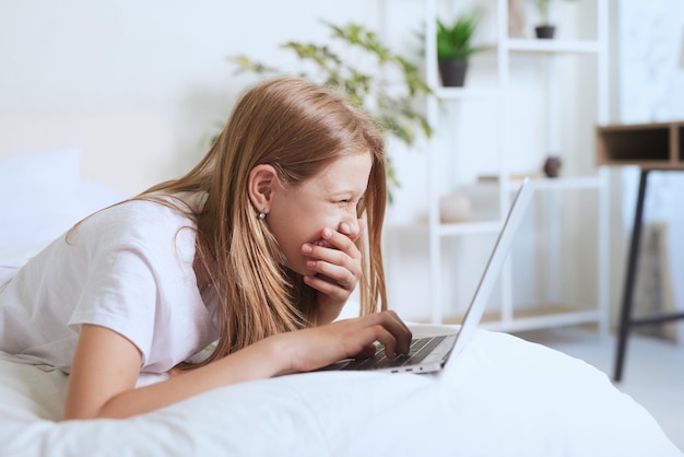 Young girl working at home on a laptop online training