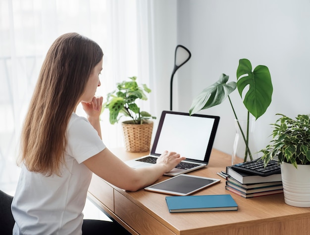 Young girl working at home office at the table