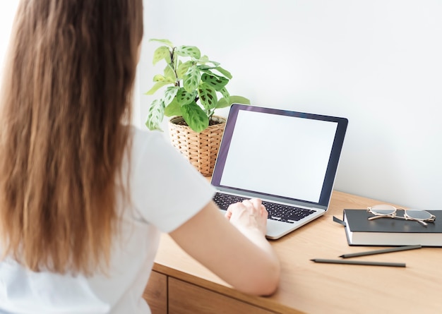 Young girl working at home office at the table