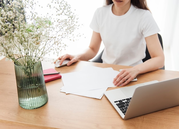 Young girl working at home office at the table