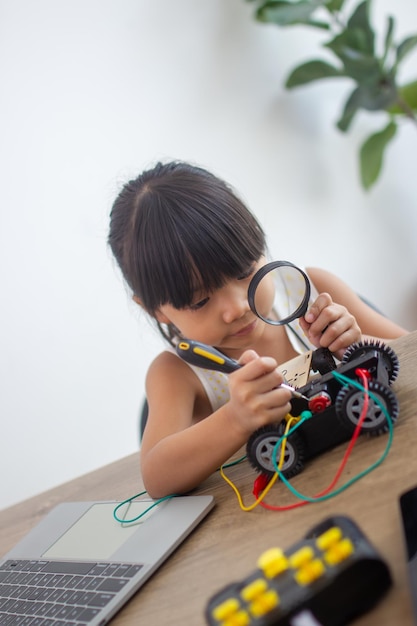Young girl working on a robot design