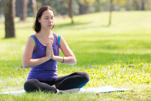 young girl yoga in park