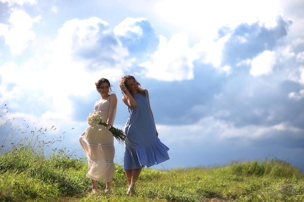 Young girls are walking in the field