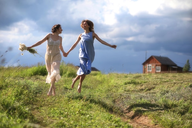 Young girls are walking in the field