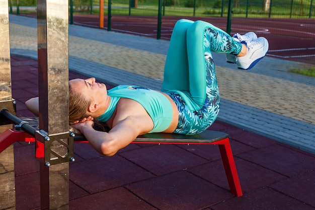 Young girls athletes are engaged in the morning on the sports field Fitness exercises