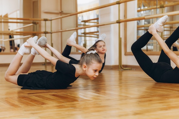 Young girls doing gymnastic exercises or exercising in fitness class
