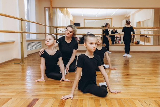 Young girls doing gymnastic exercises or exercising in fitness class