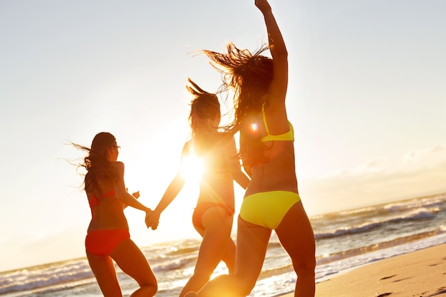 young girls enjoying the sun, sand and sea