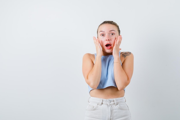 young girls is showing shocked emotion on white background