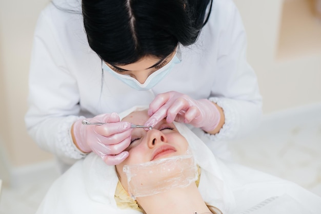 Young girls do mechanical face cleaning in a modern cosmetology clinic. Cosmetology.