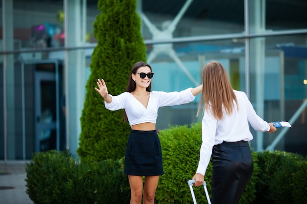 Young girls meet at the airport