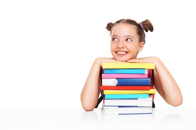 a young girls posing with a stack of books over white background