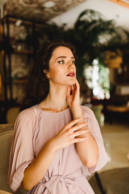 Young girls touches her face while looking at window