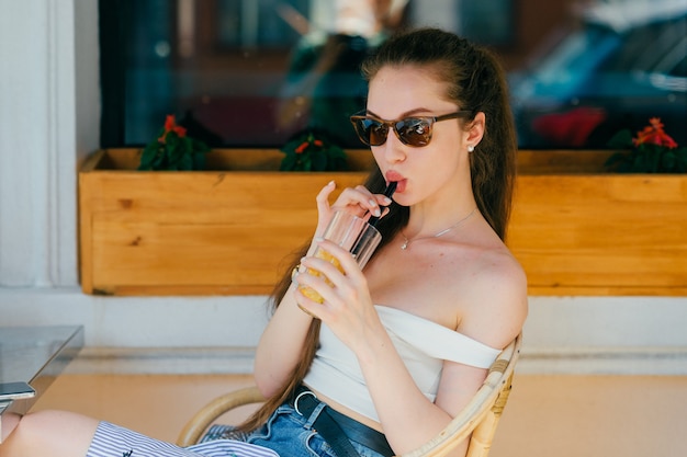 Young glamour woman drinking juice