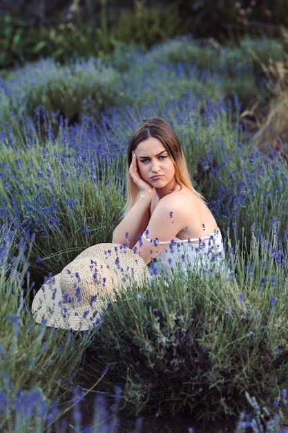 Young Gloomy Woman is frowning in Lavender Meadow