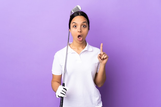 Young golfer woman over colorful wall thinking an idea pointing the finger up