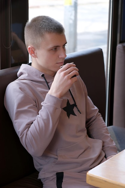 Young goodlooking guy drinking coffee