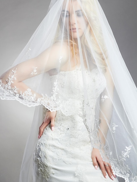 Young gorgeous bride woman with veil