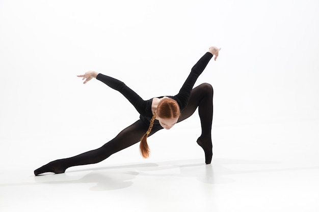 young and graceful ballet dancer in minimal black style isolated on white studio background