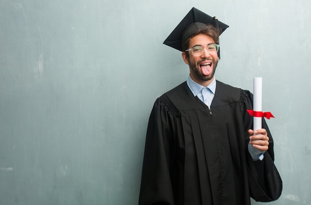 Young graduated man against a grunge wall with a copy space expression of confidence and e