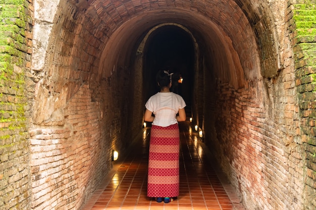 Young grils traveling Wat Umong Suan Puthatham Temple  Old temple made from wood know as landmark