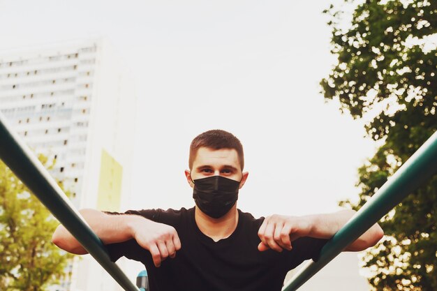 Young guy, an athlete engaged on uneven bars