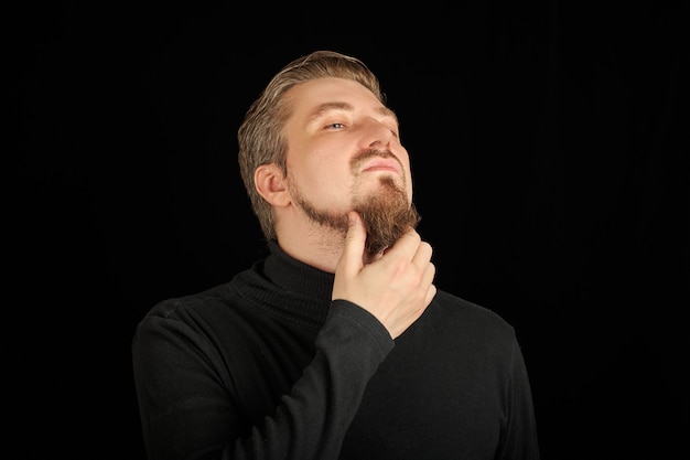 Young guy in black polo neck sweater