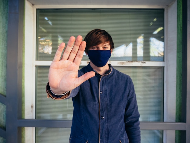 Young guy in a blue jacket and mask.