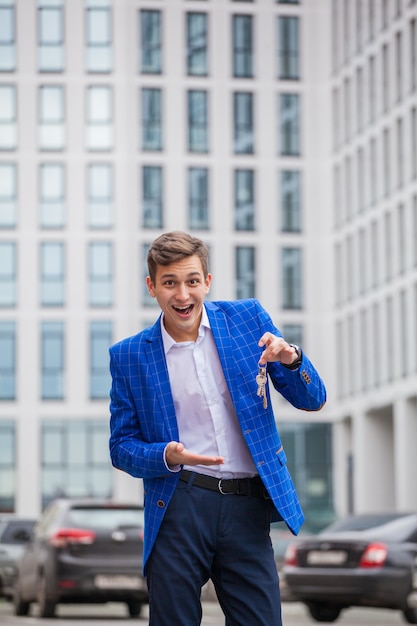 A young guy bought an apartment. Keys in hands