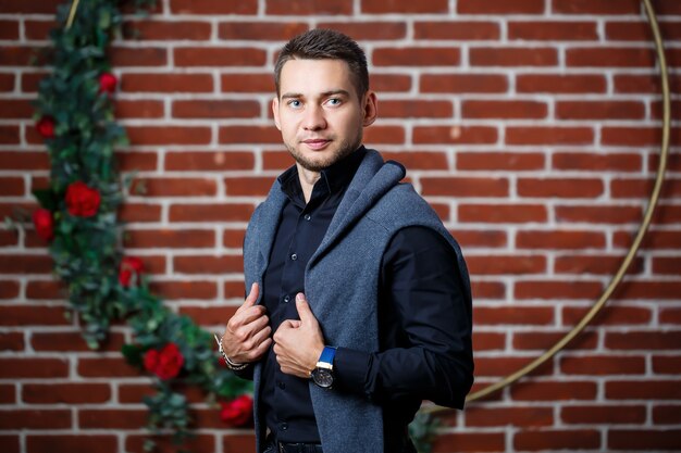 Young guy businessman in a shirt on a sofa