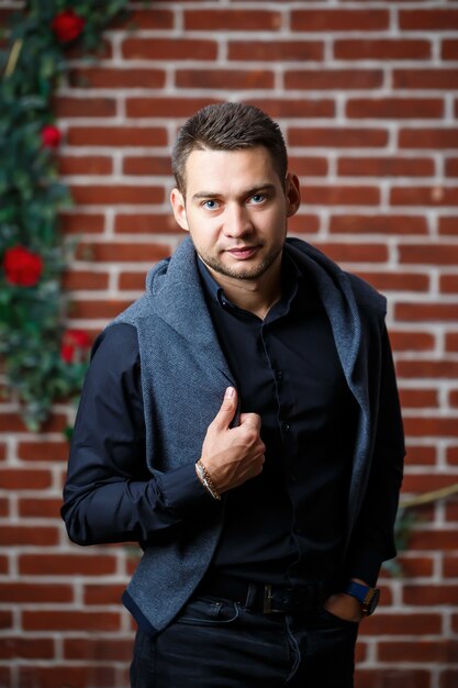 Young guy businessman in a shirt on a sofa