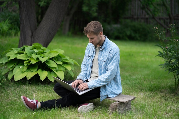 A young guy doing remote work on the vacation typing on laptop