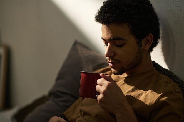 Young guy drinking hot tea