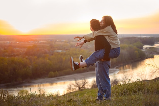 young guy and girl have fun in the evening in nature