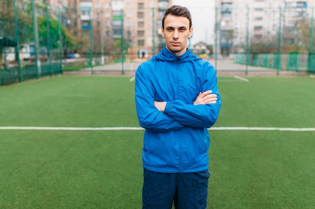 A young guy goes in for sports, portrait, handsome guy in sportswear. The guy works in the open, fresh air.