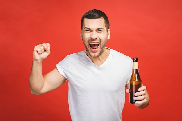 Young guy holding a bottle of beer