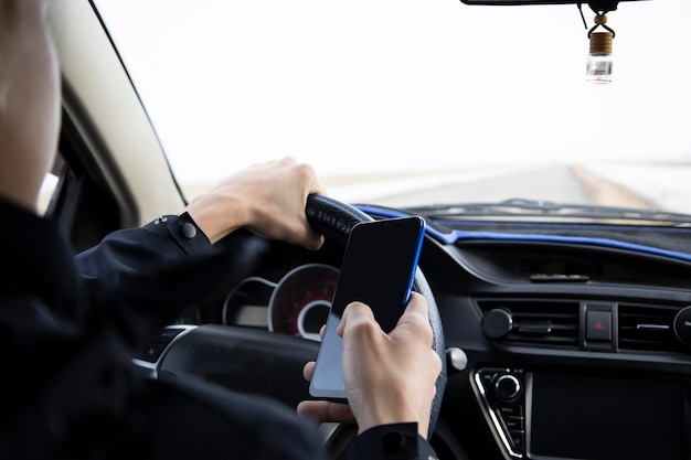 A young guy is talking on the phone while driving a vehicle