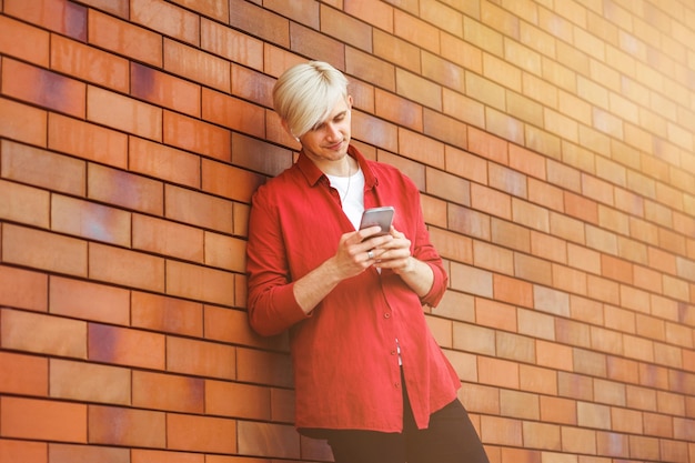 Young guy looking at his smart phone