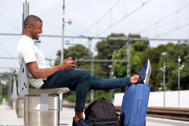 Young guy waiting at railway station 