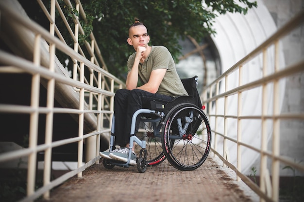 Young guy on a wheelchair disability difficulty moving people\
with disabilities