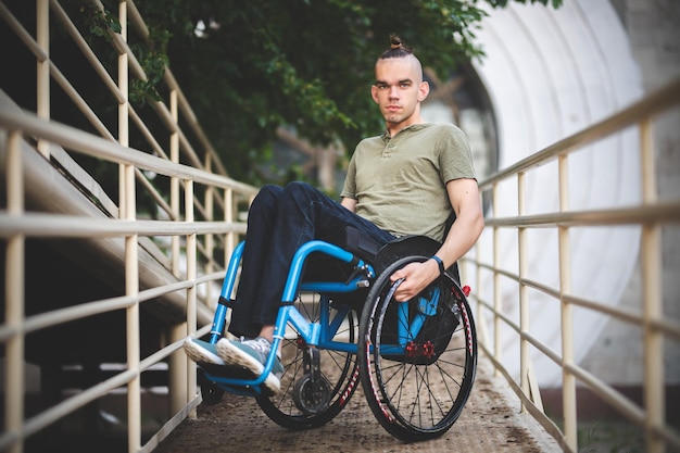 Young guy on a wheelchair disability difficulty moving people
with disabilities