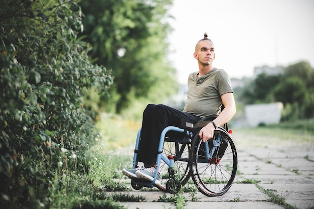 Young guy on a wheelchair disability difficulty moving people\
with disabilities