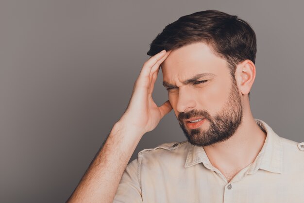 Young guy with big problems having strong headache