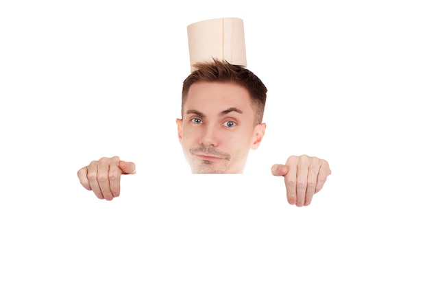 Young guy with roll of toilet paper on his head on isolated white background. Copy space.