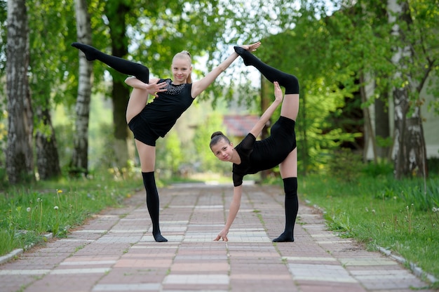 Young gymnast girls posing outdoor