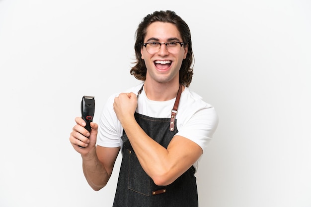 Young hairdresser man isolated on white background celebrating a victory