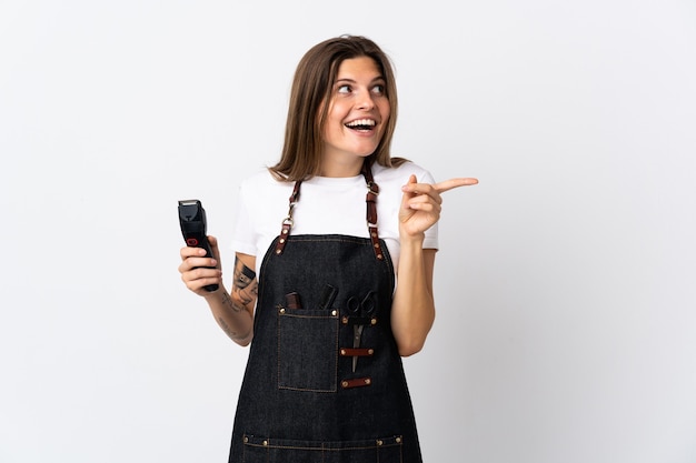 Young hairdresser slovak  woman isolated on white wall intending to realizes the solution while lifting a finger up