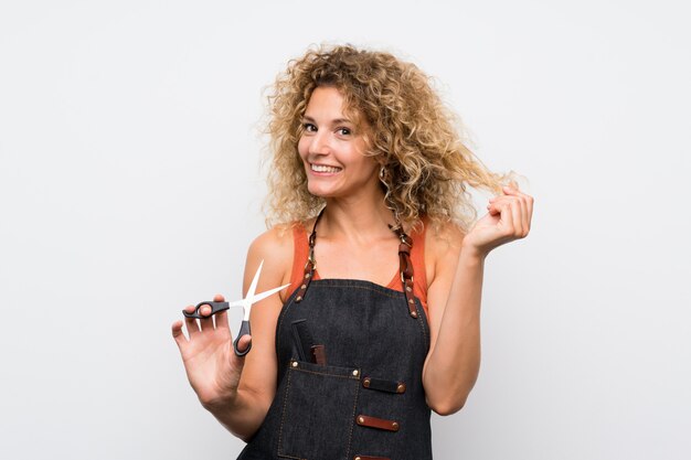 Young hairdresser woman over  wall